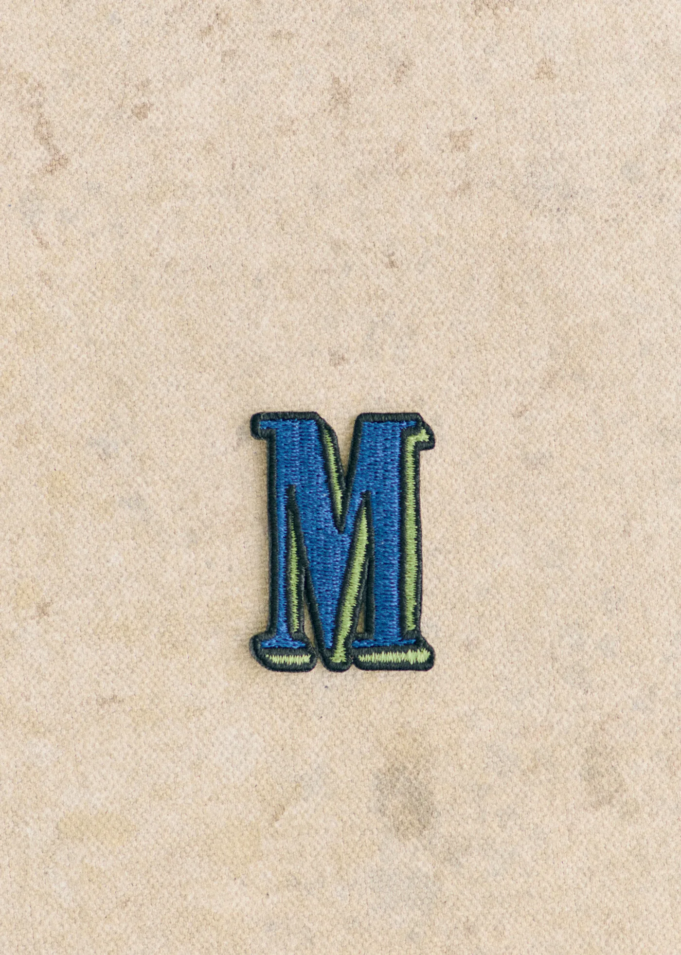 Ecusson vert / bleu - Lettre M - Bleu